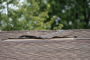Roof with damaged shingles in need of repair.
