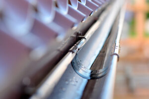 Close-up on metal half-round gutter on a house.