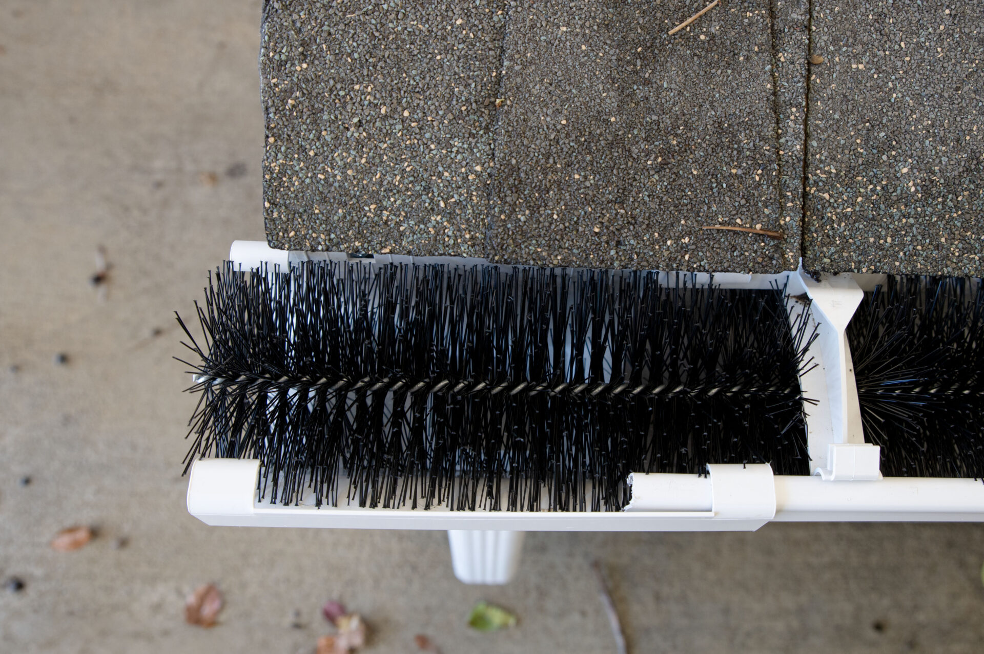 Brush gutter guards on a home gutter system.