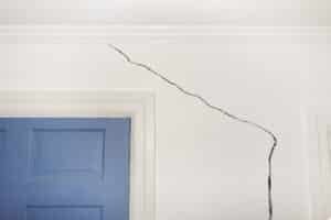 Cracked drywall above a door