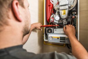 man working on furnace