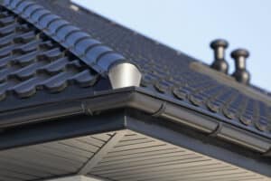 Metal roof with black half-round gutters.