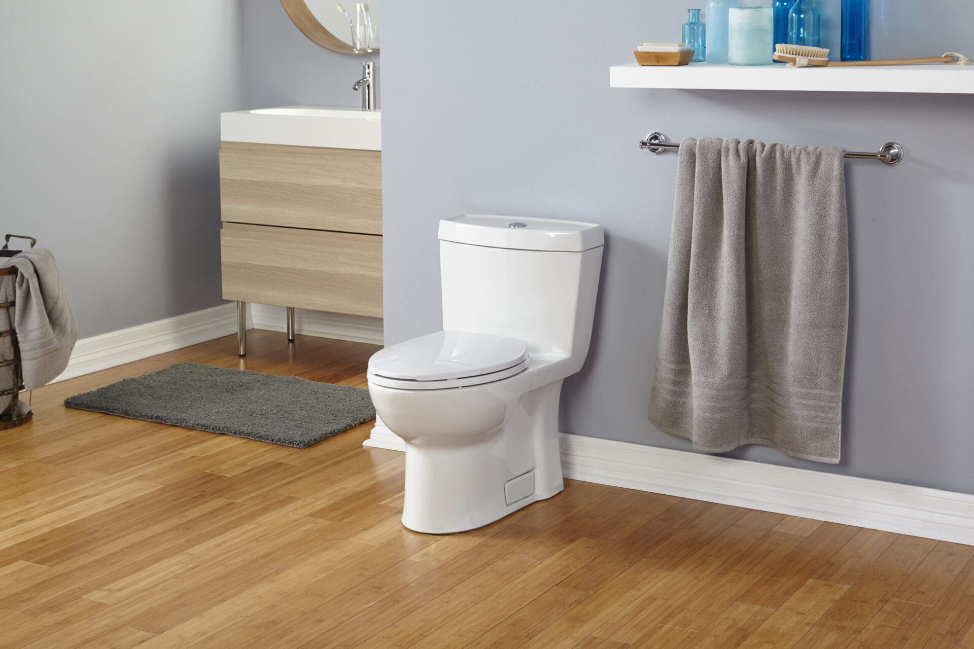 A one-piece toilet in a gray bathroom.