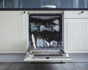 Best dishwasher hero image - An open dishwasher with dishes inside. Best Dishwashers, best dishwasher hero image. Open dishwasher washing dishes.