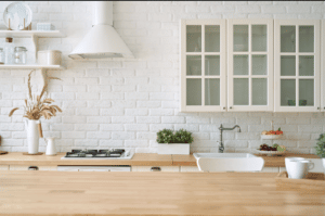 Bright kitchen with glass-front cabinets and cooktop.